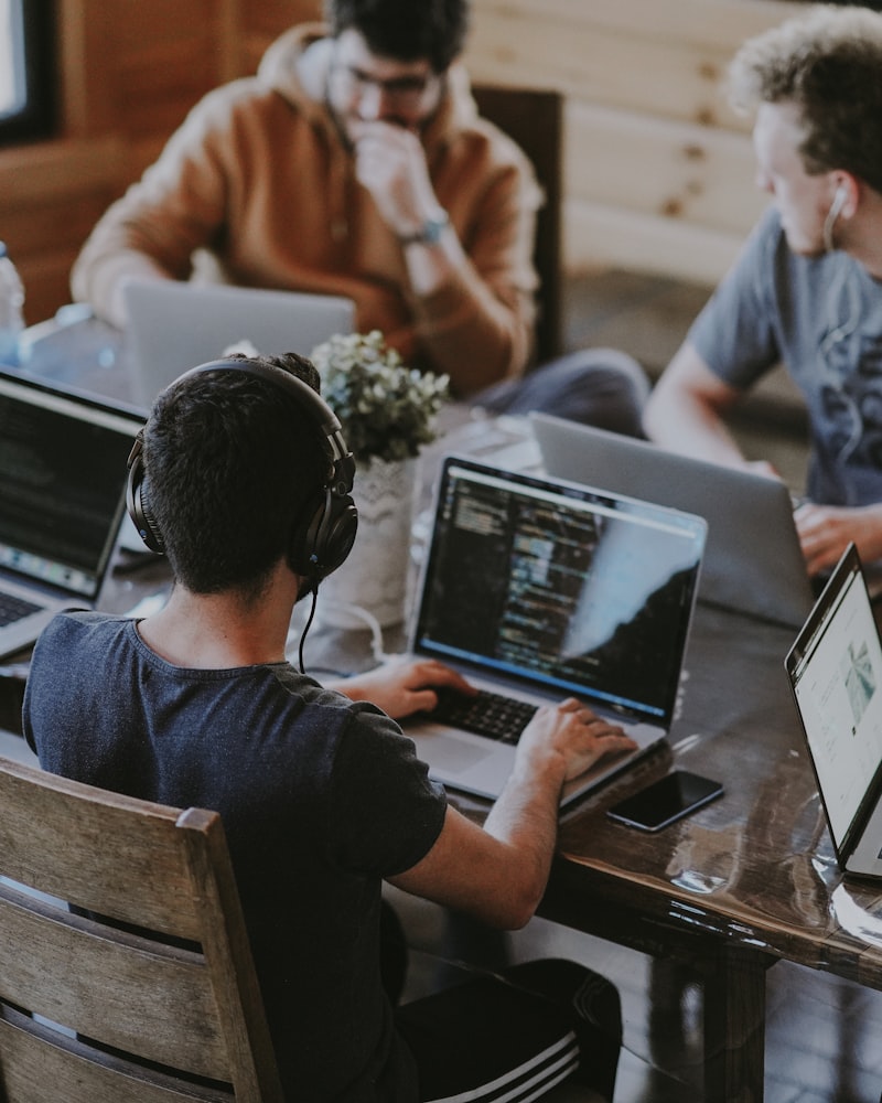 Young students working on code together in a tech workspace